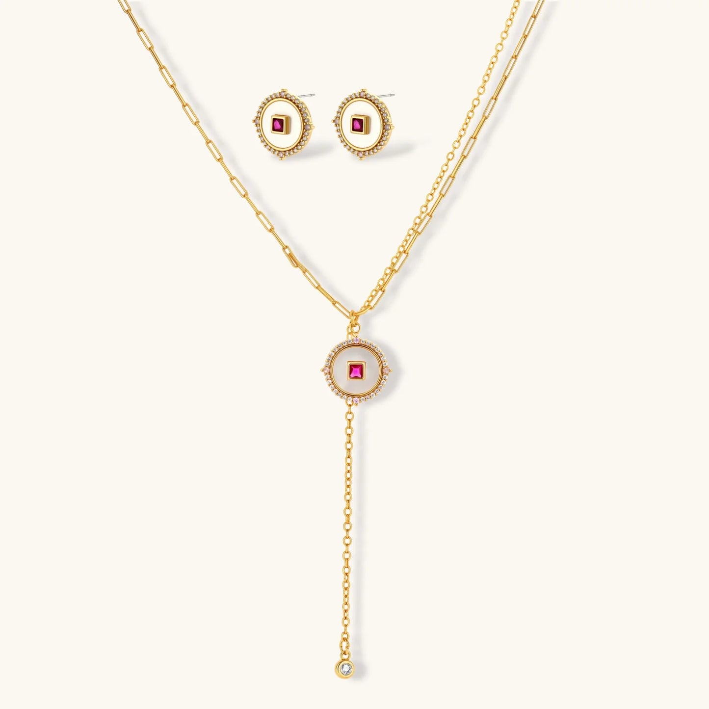 Gold-plated circular medallion necklace set with white enamel base and pink cubic zirconia accent stones